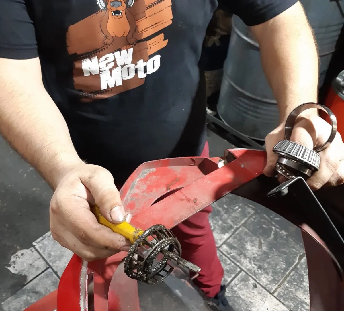 Mecânico da New Moto Point fazendo manutenção em uma moto na oficina da Av. Farrapos